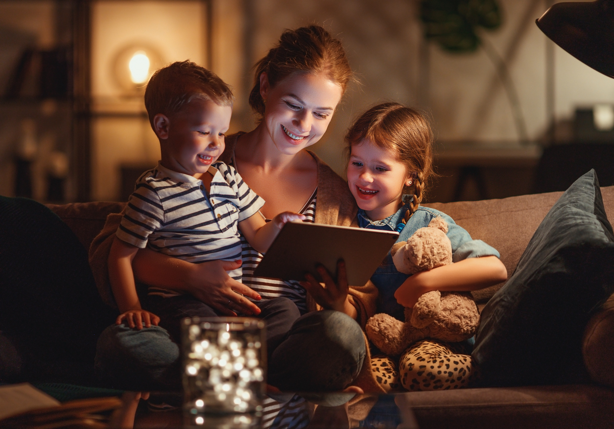 Evening family reading. mother reads children . book before going to bed.